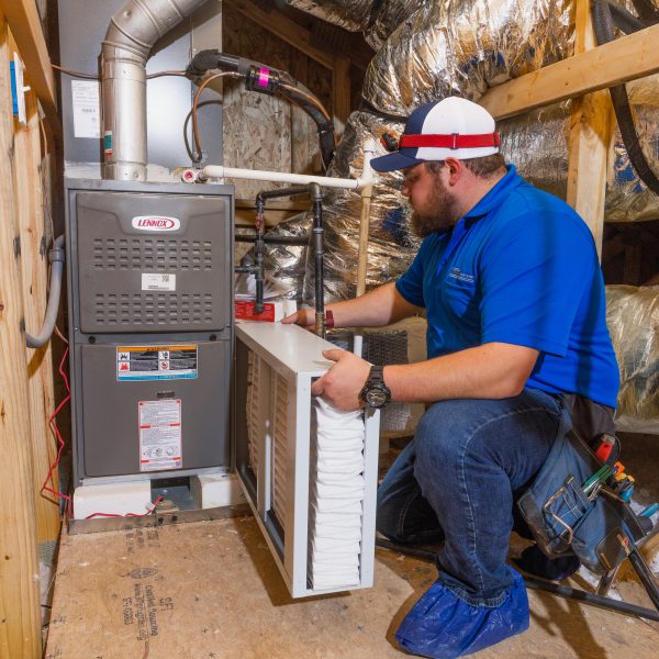 Technician installing HVAC system